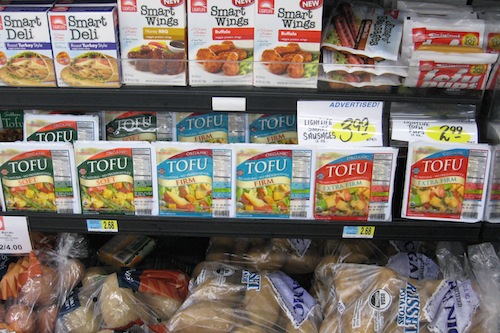 An image of the tofu section of a grocery store