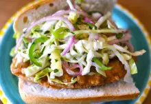 A Vegan Fried Chicken Sandwich topped with slaw.