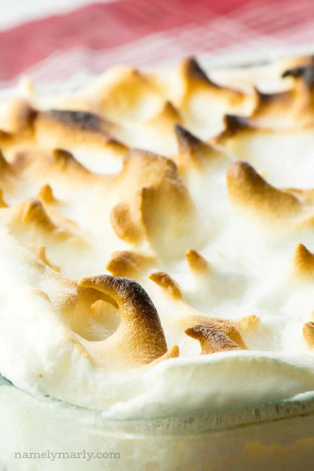 A close-up of vegan meringue shows golden peaks.