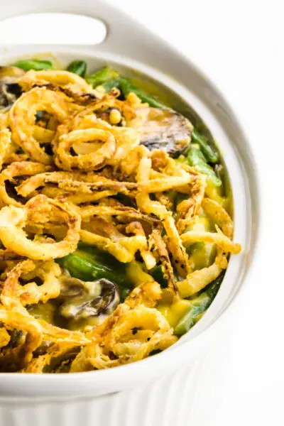 A casserole shows fried onions in a casserole dish with green beans.