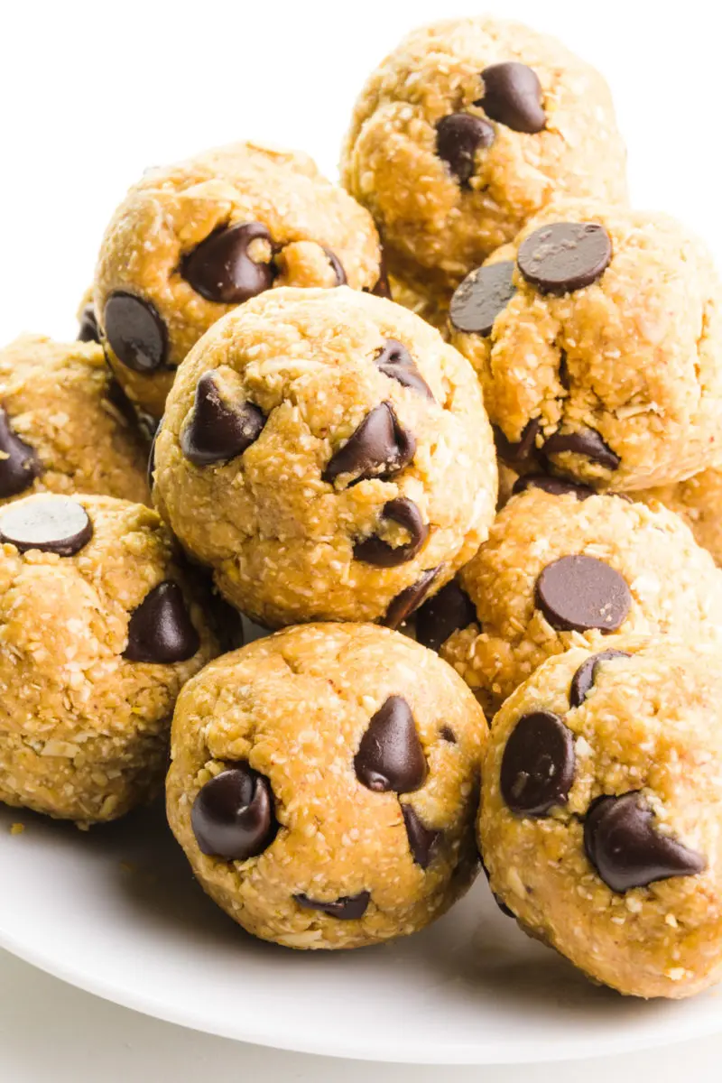 A plate holds several cookie dough bites, all with lots of chocolate chips!