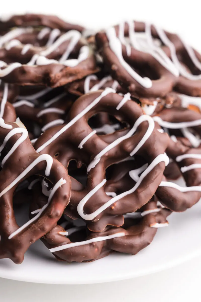 A plate of dark chocolate covered pretzels.