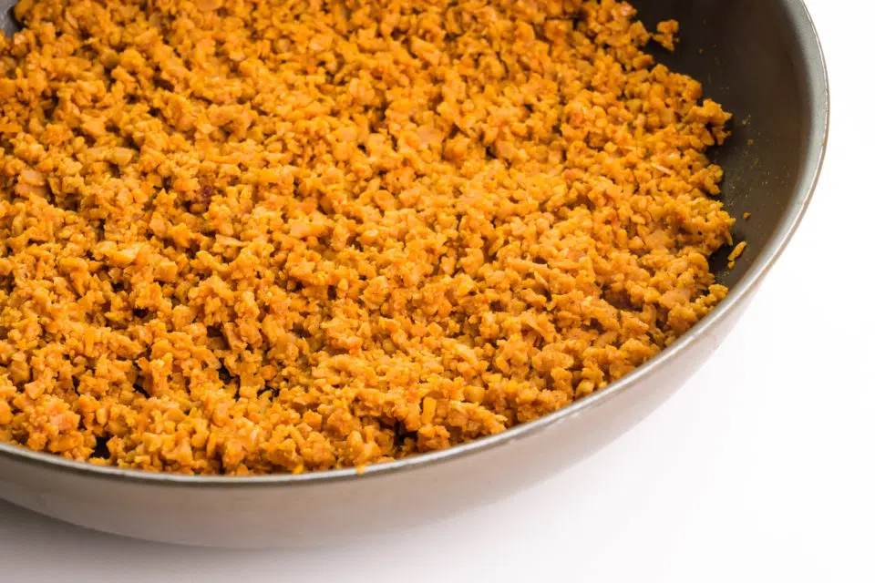 A skillet holds vegan beef crumbles.