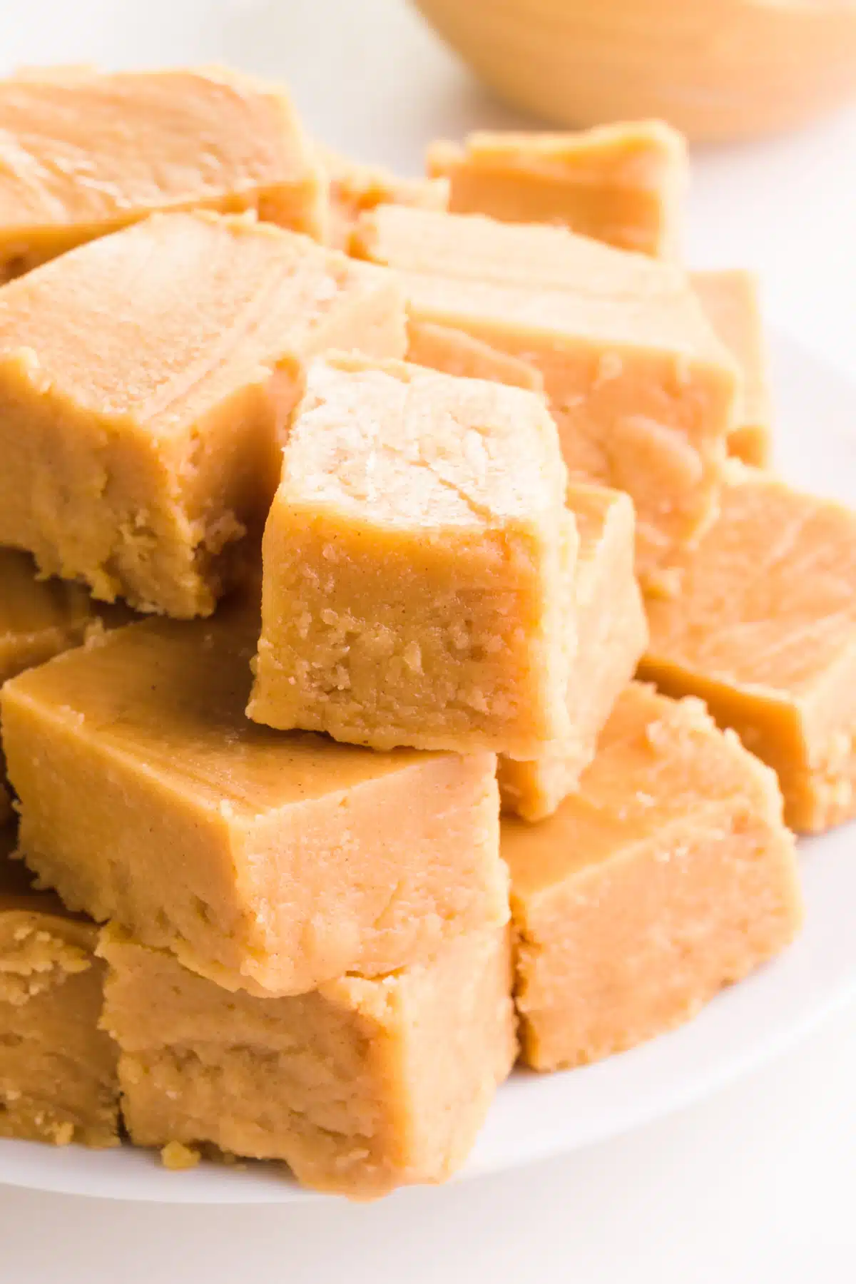 A stack of vegan peanut butter fudge sits on a plate.