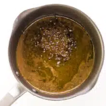 A hot sugar mixture is coming to a boil in a saucepan.