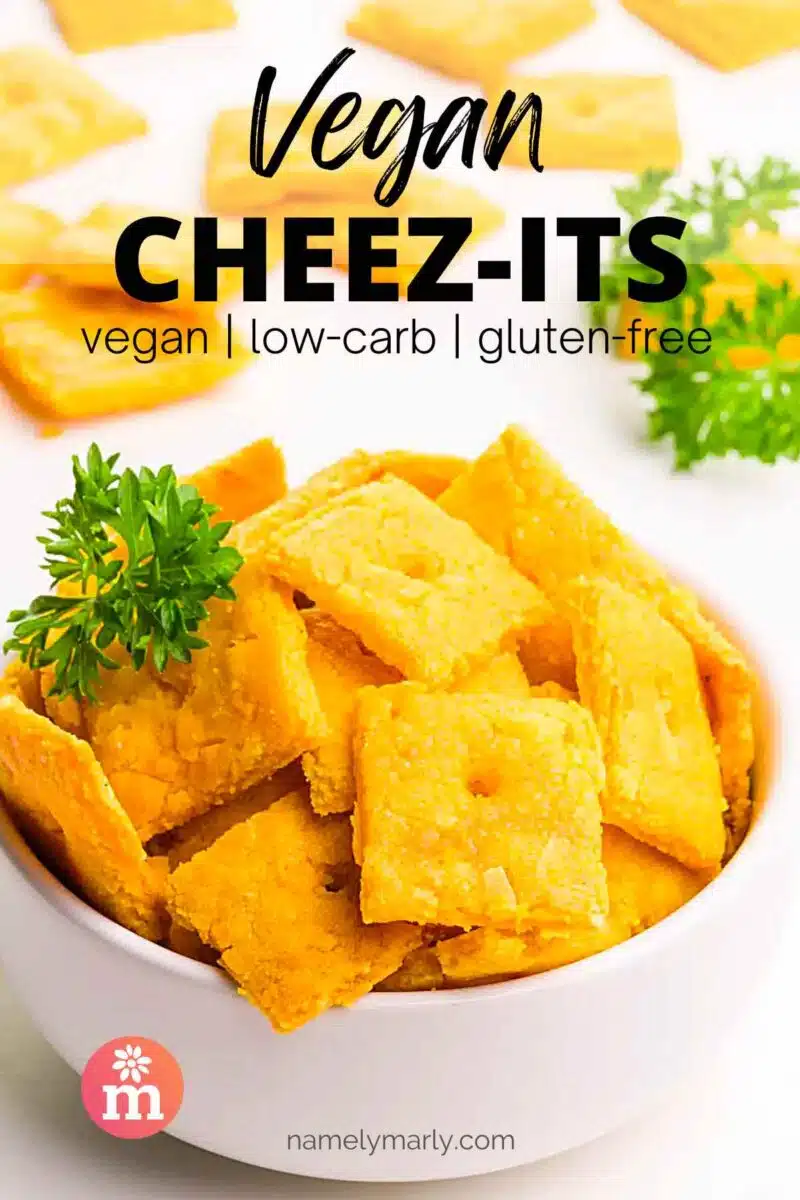 A small bowl of cheez-its sits in front of more of the crackers in the background. The text reads, Vegan Cheez-its.