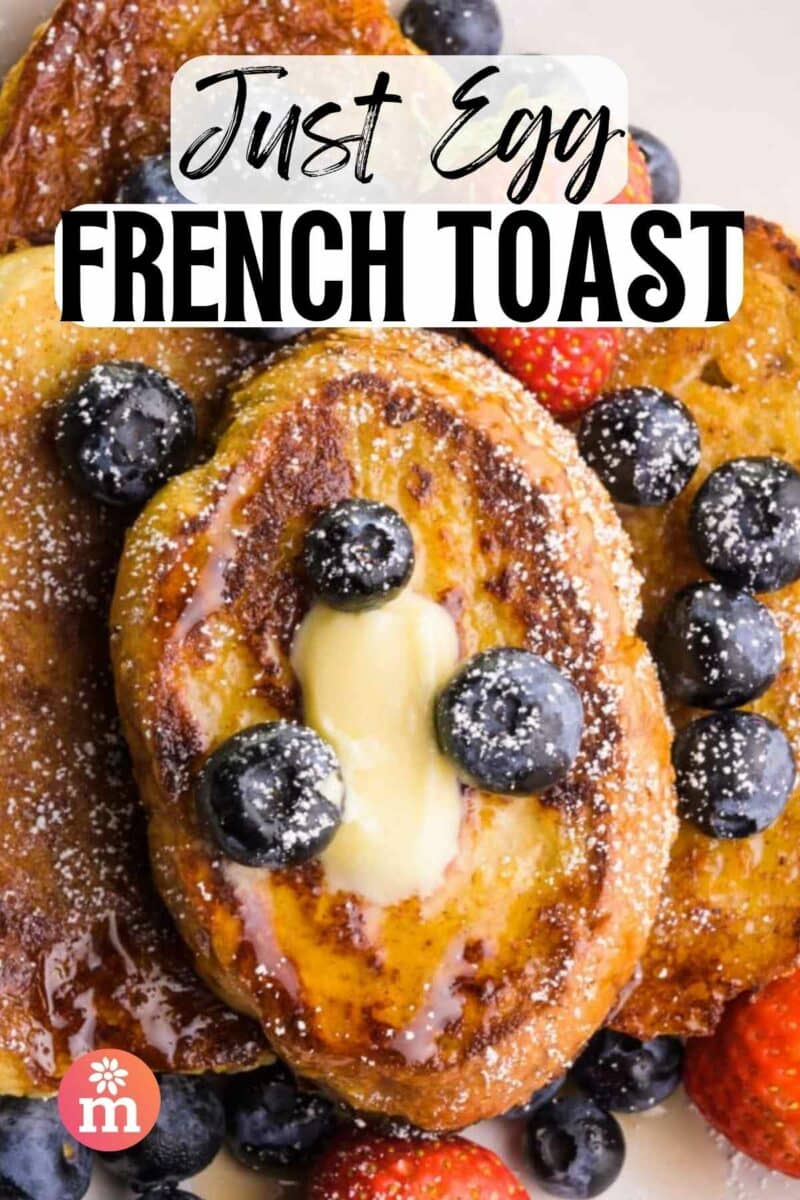 Looking down on a plate of French toast slices with melted butter and blueberries. The text reads, Just French Toast.