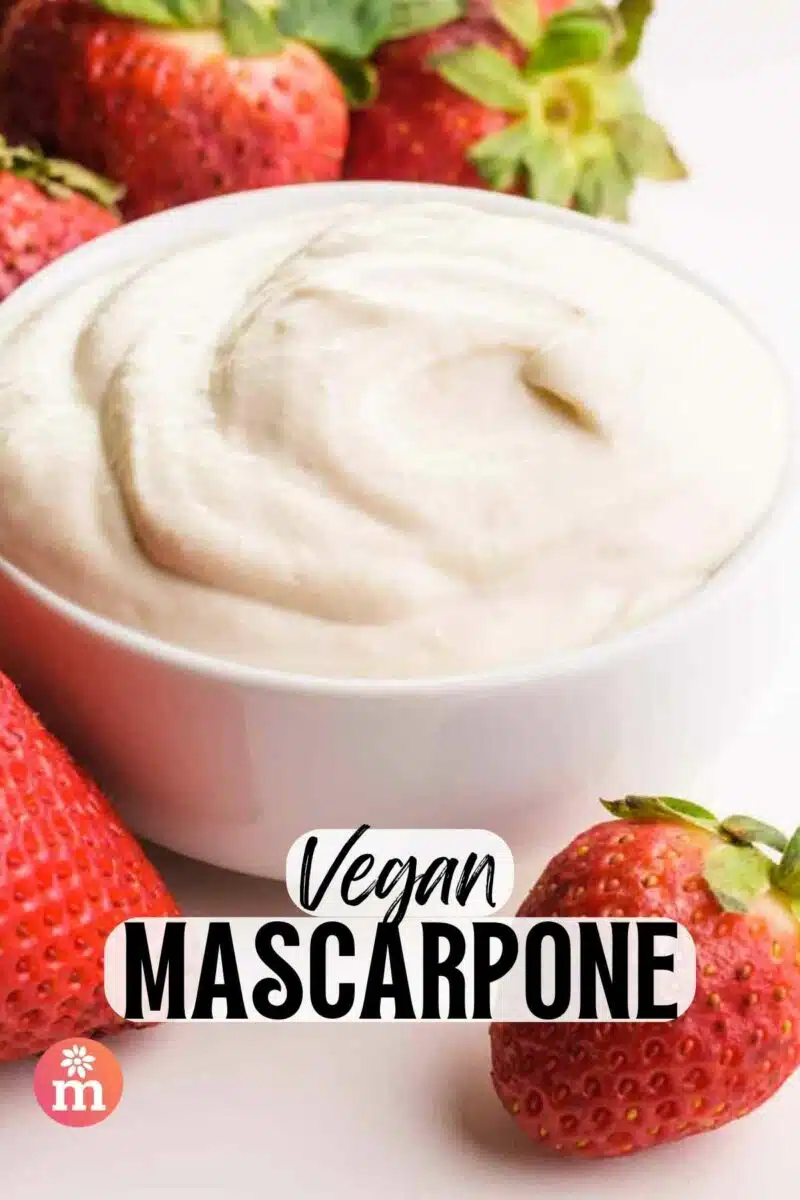 A bowl of cream sits around fresh strawberries. The text reads, Vegan Mascarpone.