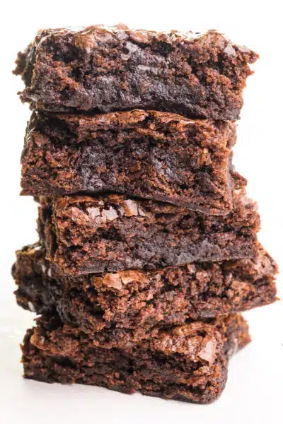 A stack of five brownies sits on a white counter top.